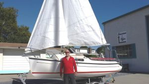owner posing with new sailboat
