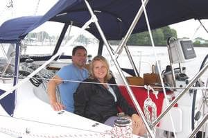 happy couple sitting on new boat