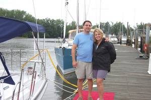 happy couple posing on dock