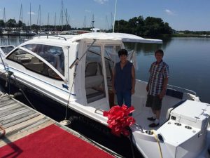 happy owners aboard their new boat